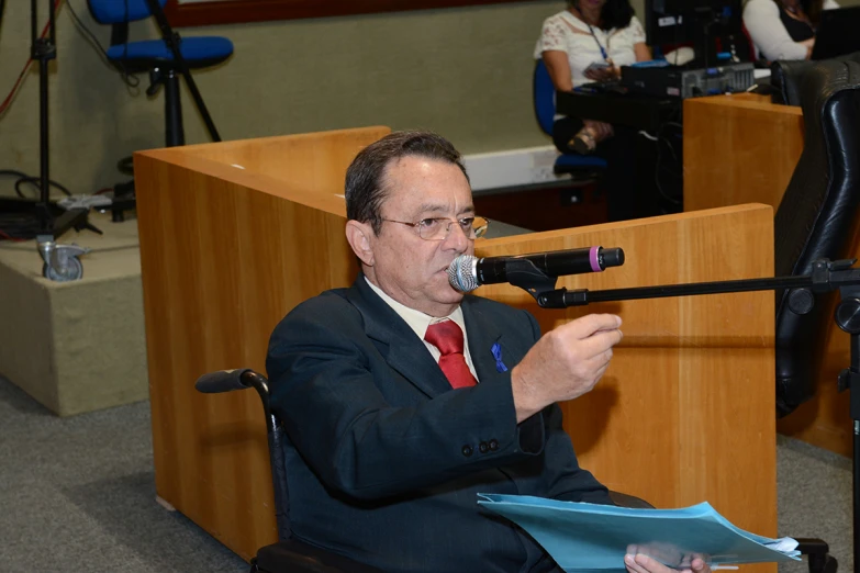 a man speaking into a microphone at a podium