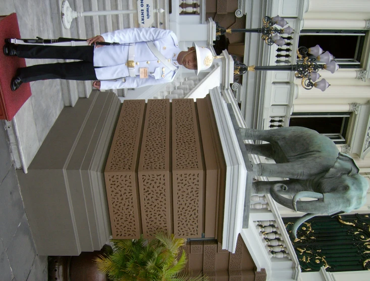 two men in military clothing standing by a shrine