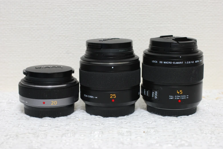 three lenses in different sizes, all sitting next to each other