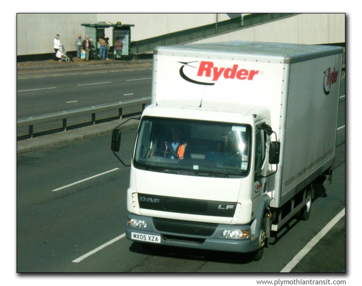 a rider is riding a commercial vehicle on the road