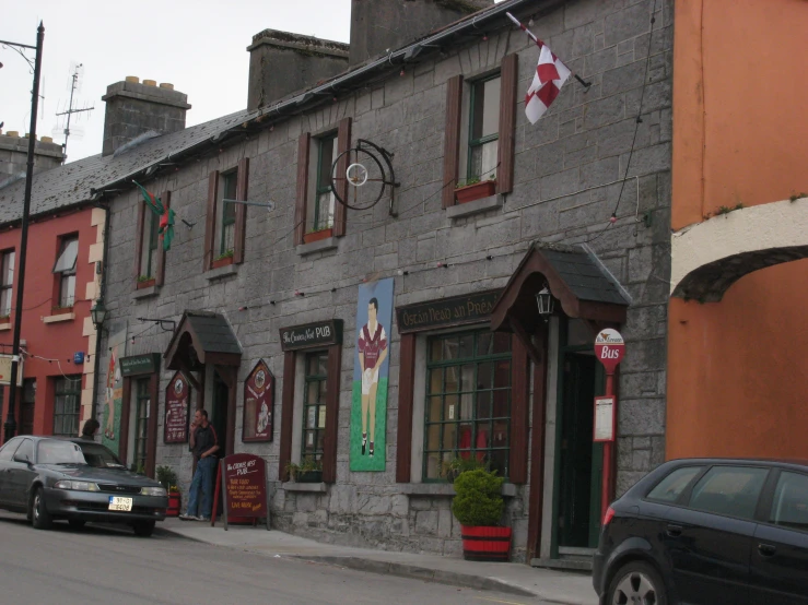 cars parked in front of a grey building