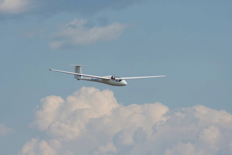 an airplane is flying through the sky over clouds