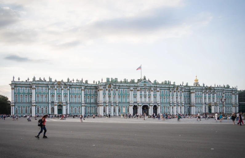 some people walking around in front of a building