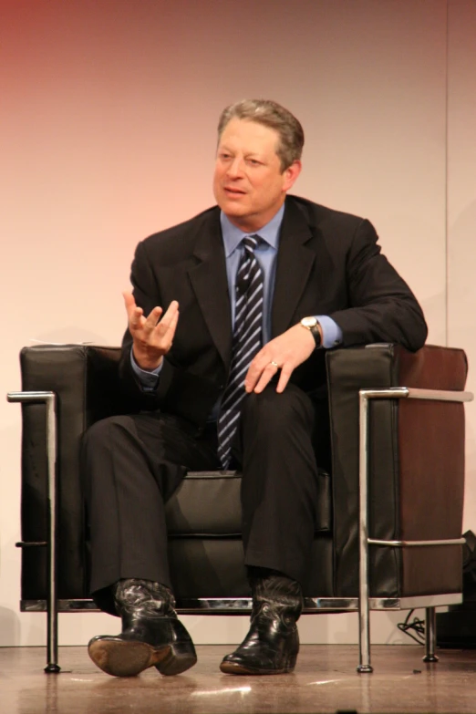 a man in a suit is sitting on a chair