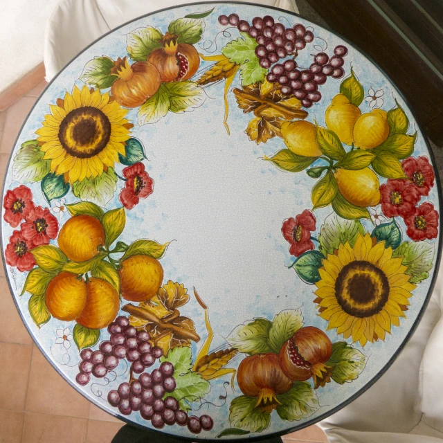 a decorative plate with gs and sunflowers painted on it