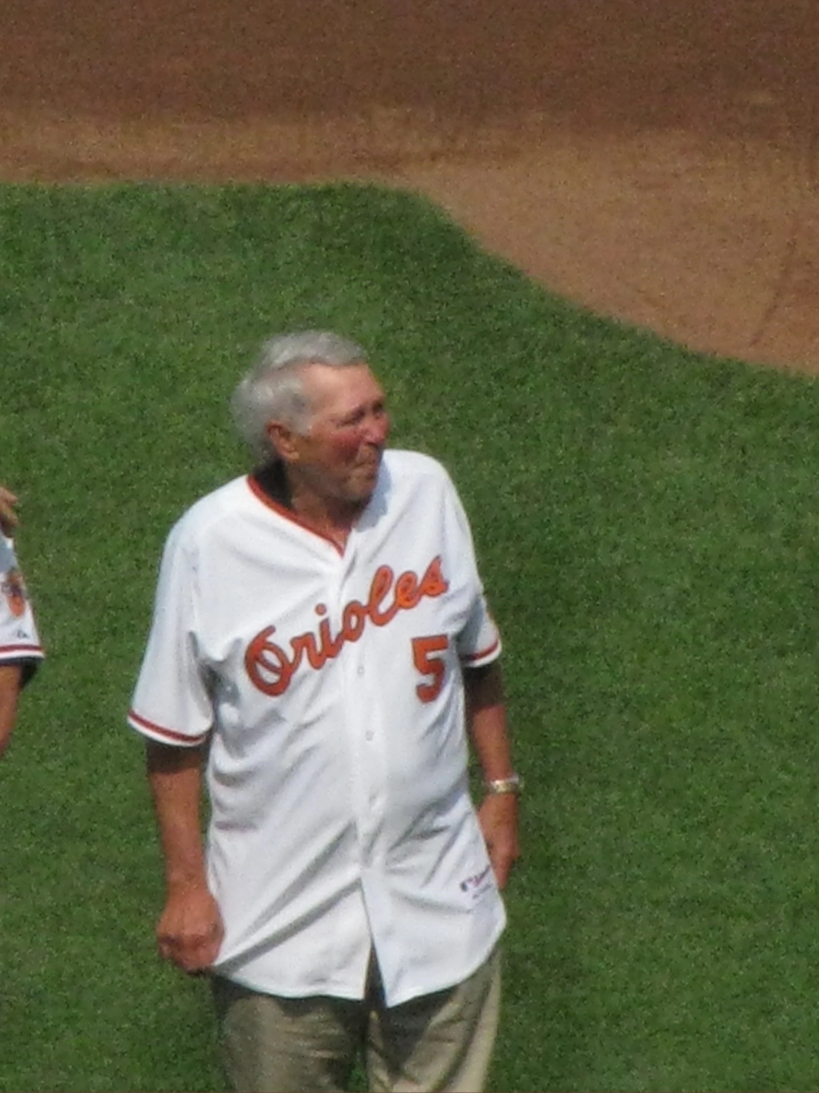 a couple of men standing next to each other on a baseball field