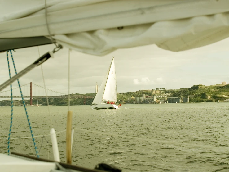 the sail boat is heading toward the bay in the daytime