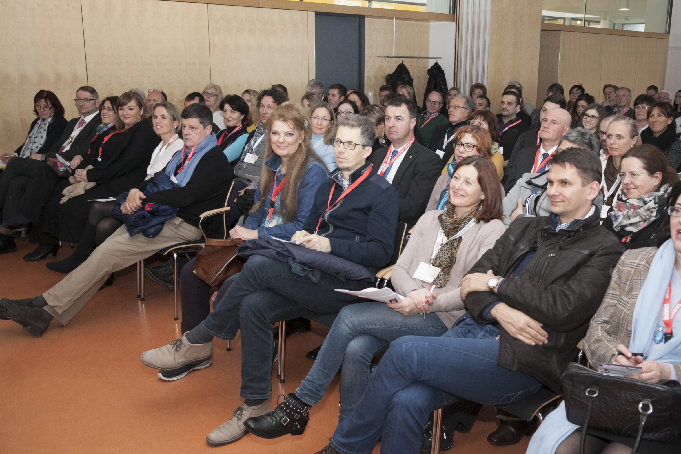 people in a conference hall looking up at soing in the audience