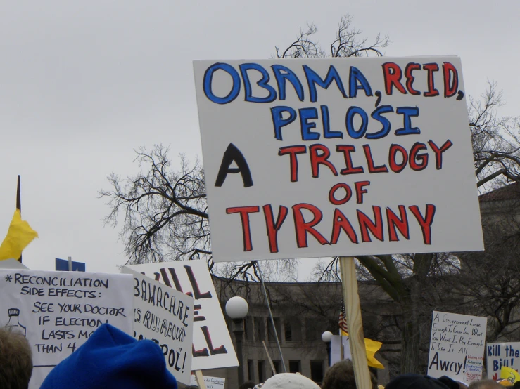 signs depicting the president and his followers in the rally