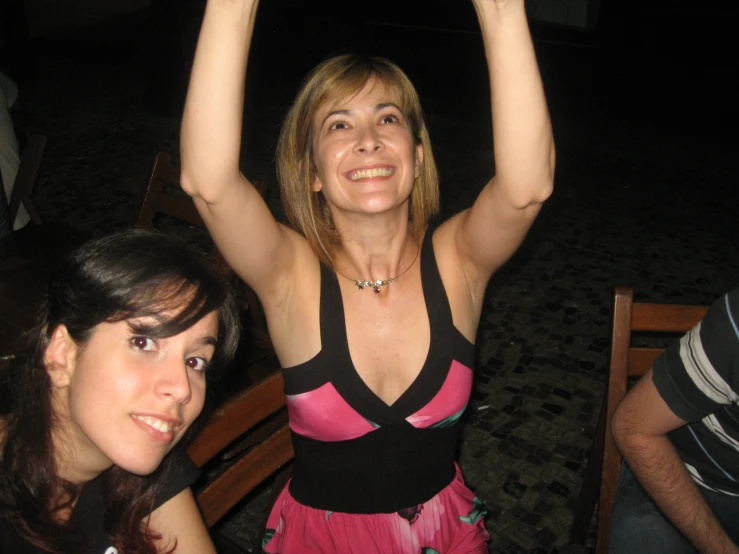a woman is holding up her arms in the air