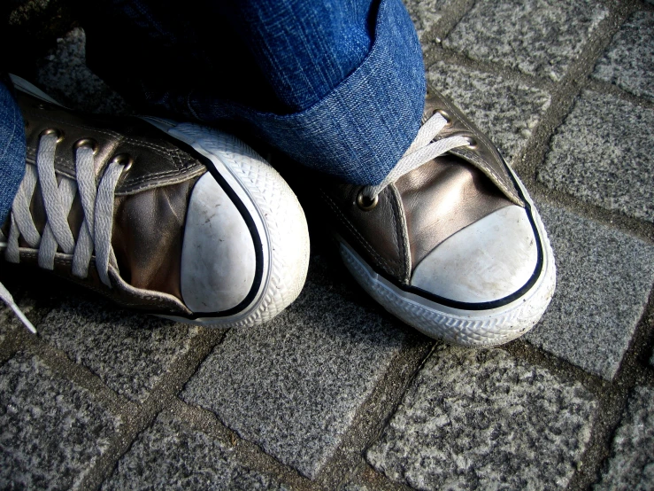 a person's feet that are wearing sneakers