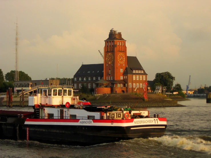 a boat floats down the water towards a town