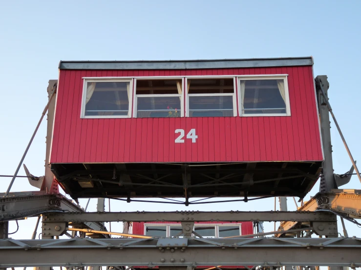 a red building with metal framing and numbers on it