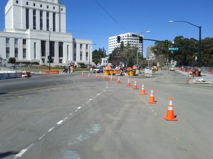 some road construction with orange traffic cones on the side