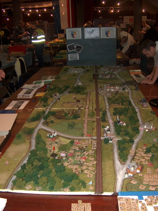 the game board is full of wooden toy cars and people