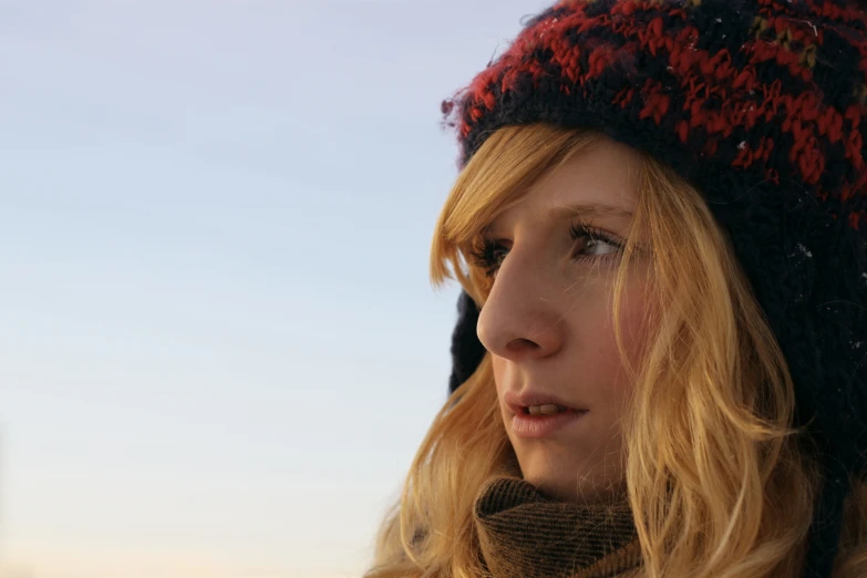 a woman standing in the snow looking back