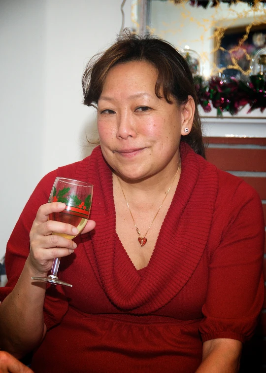 a woman in a red sweater is drinking soing