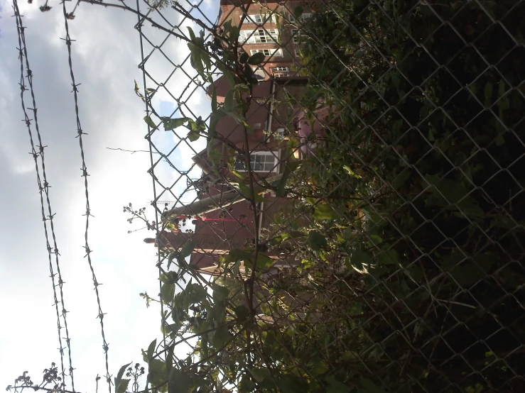 a building is in the background behind a fence