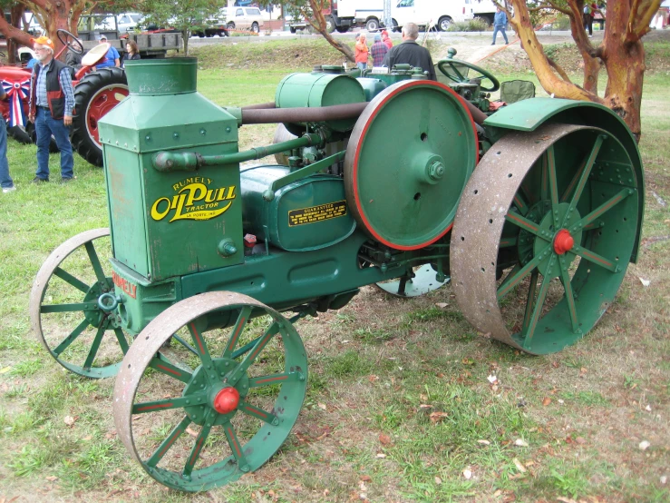 an old tractor is parked in the grass