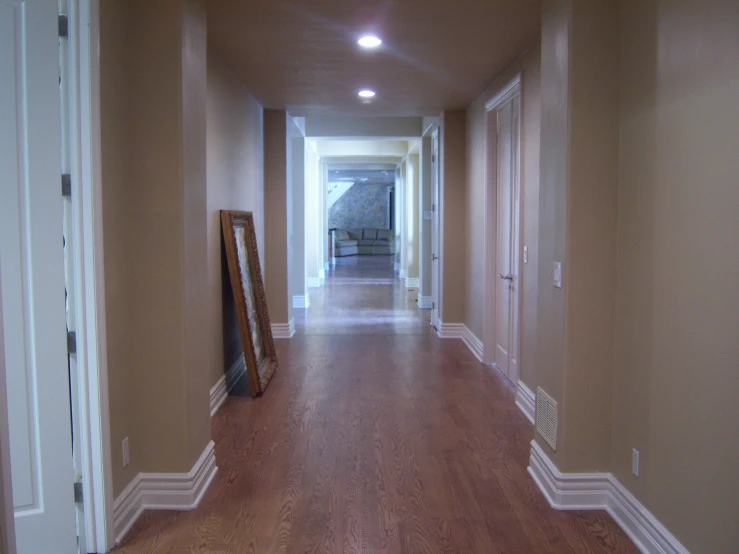 empty hall leading to several doors and mirrors