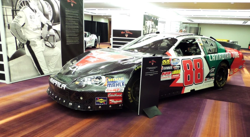 a race car is parked inside of a show room