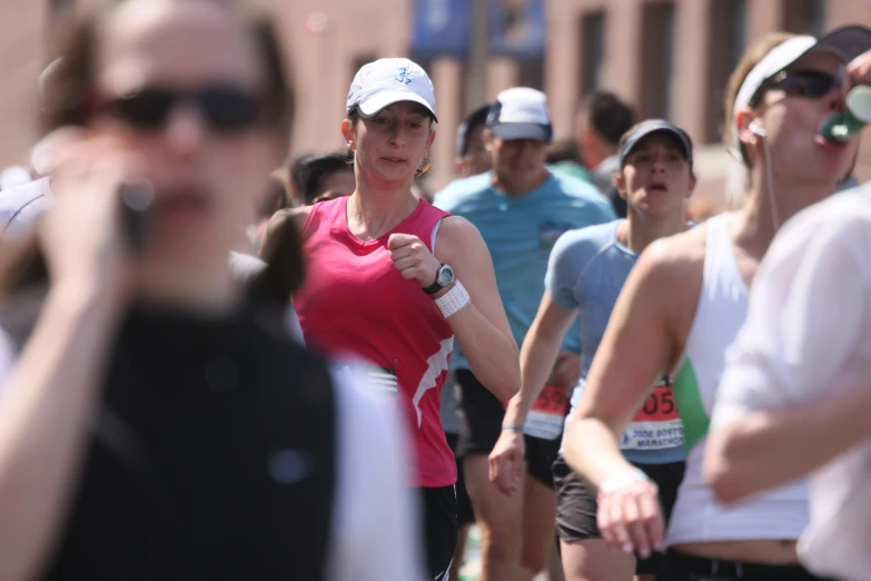 a woman in sunglasses running in a half marathon