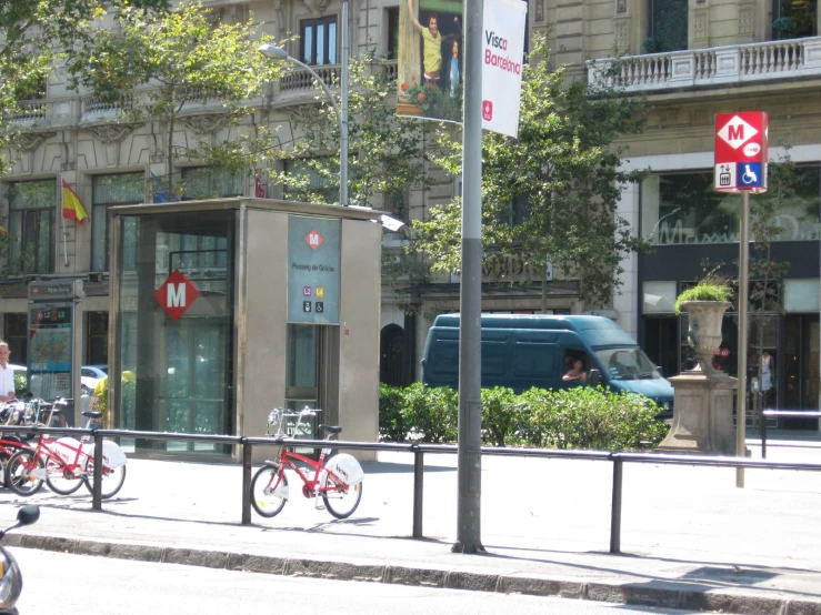 three bikes parked next to a stop sign