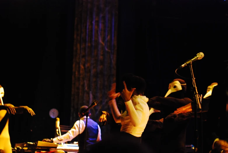 a group of people with microphones in front of some music instruments