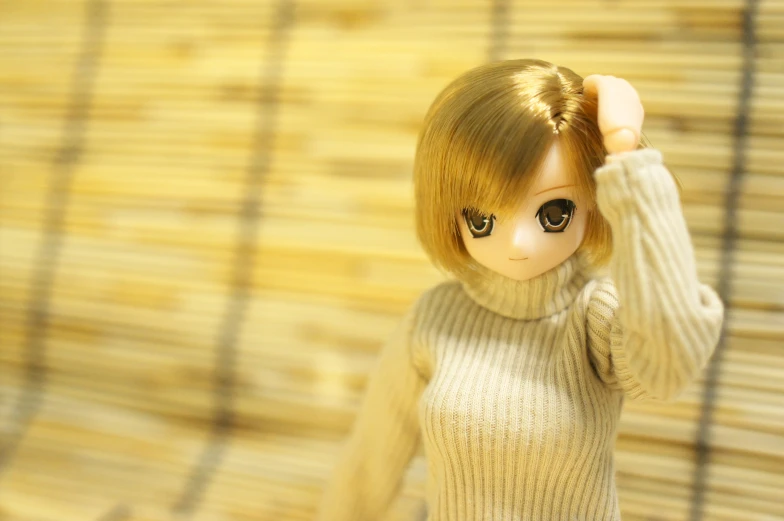 a doll is posed in front of a bamboo sheet