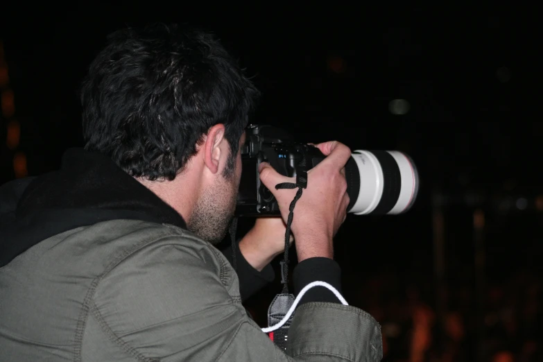 a man holding a camera near his face