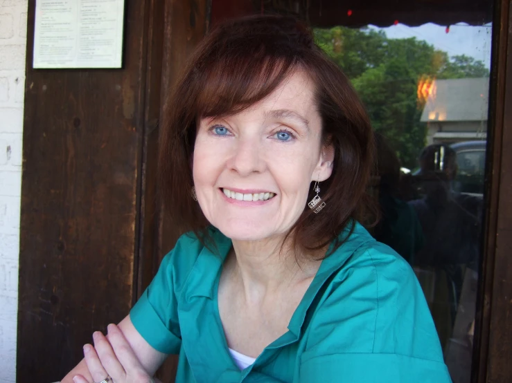 a woman with short hair and wearing a blue top