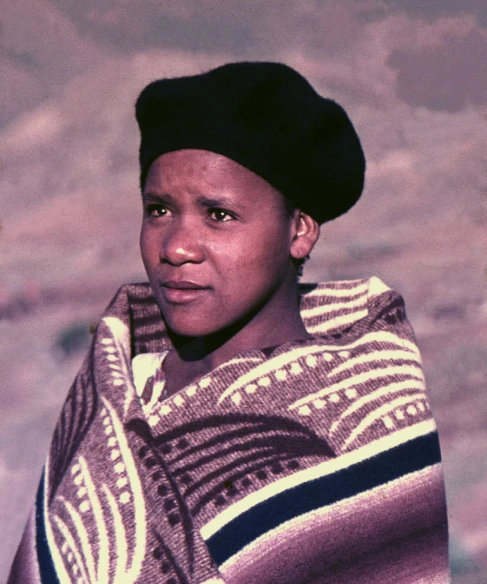 a woman in a native costume is looking at the camera