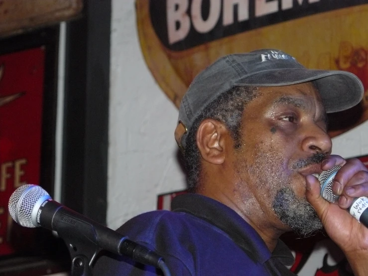 an older man with hat and microphone