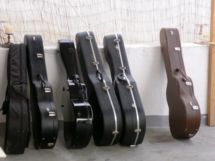 the three guitar cases are all different types of guitar