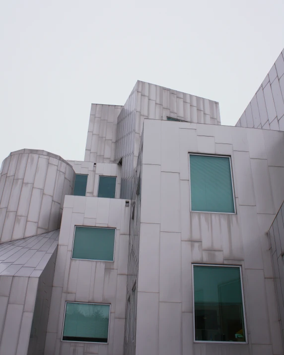 a grey building with many windows and a clock