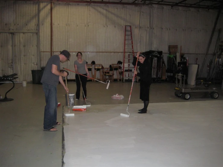 two men in a garage are doing some renovations