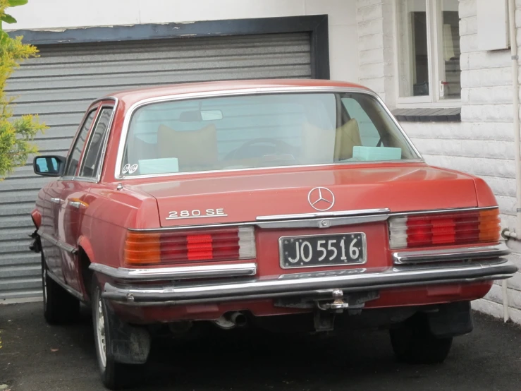 an orange car that is sitting in the driveway