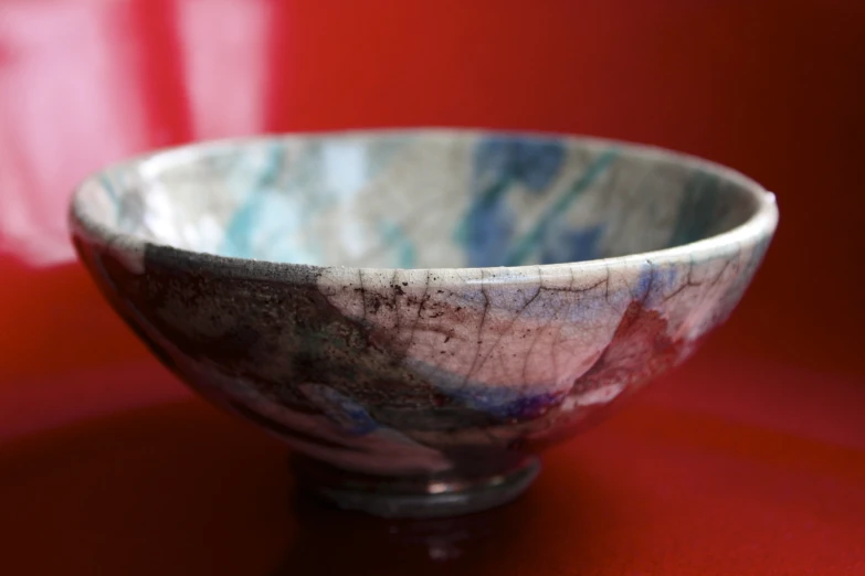 this bowl is blue and pink with some spots