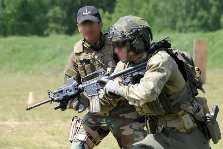 two soldiers are seen with their guns in the air
