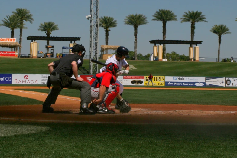 the batter is swinging at the ball during a game