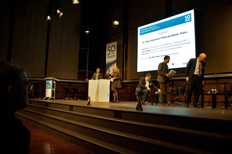 several people are at podiums and standing on steps