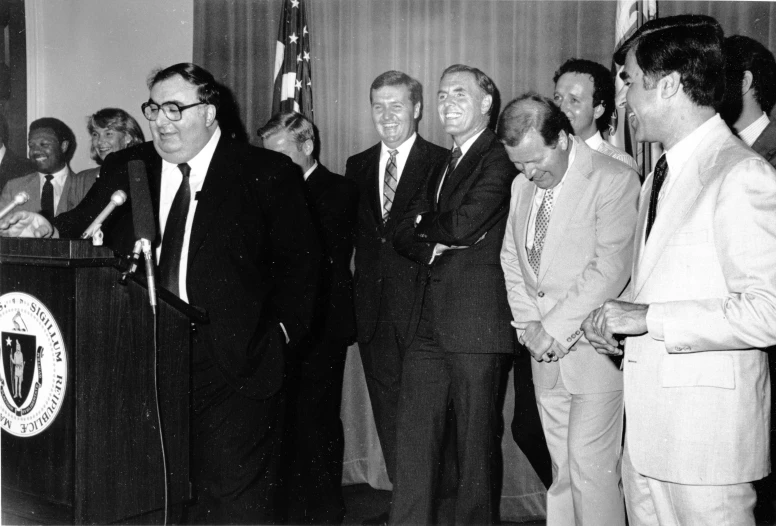 a group of men stand in front of a podium