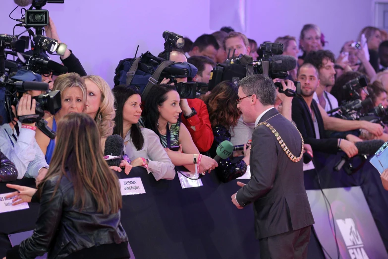 a crowd at an event with cameras around