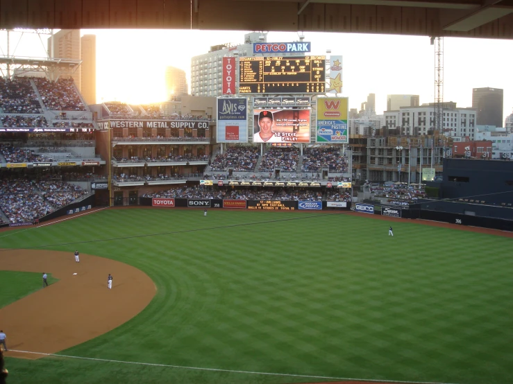 an empty baseball field with people in the stands