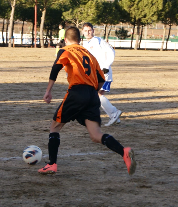 a group of men playing soccer on top of a field