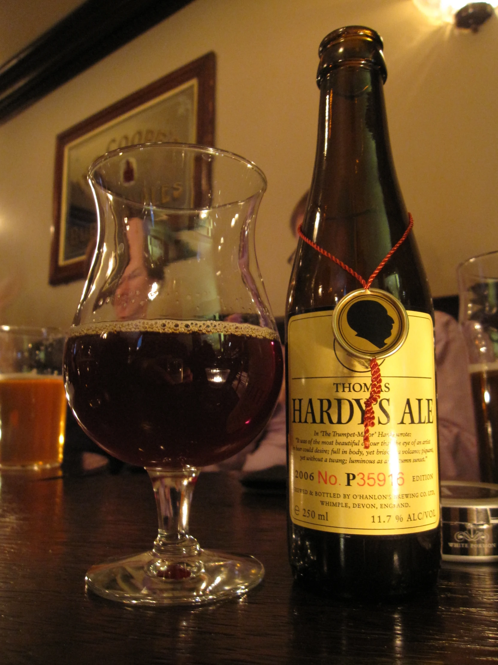 a glass and bottle sitting on top of a table