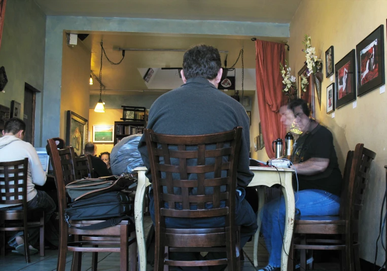 two people sitting at a table working on paperwork