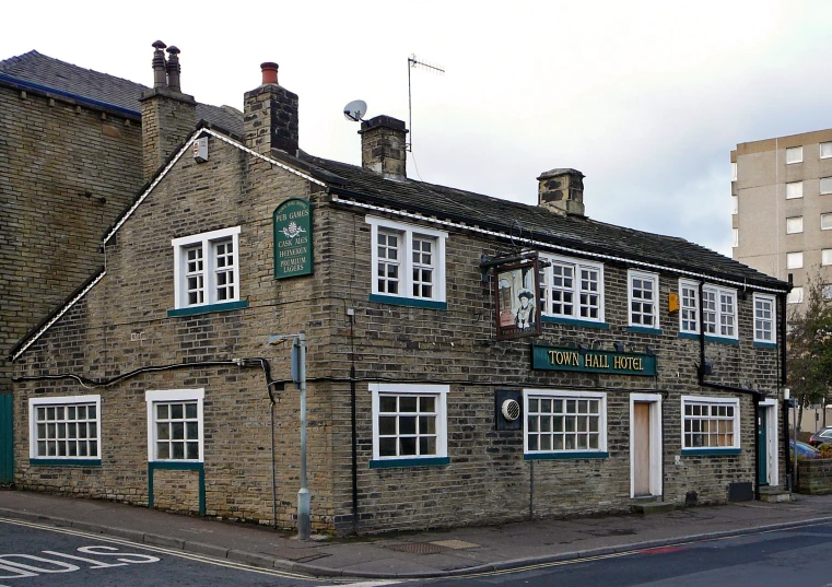 a brick building with white windows and large brick roof