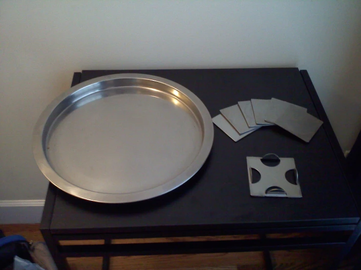 a round metal tray sitting on top of a table