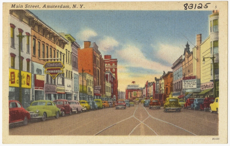 an old street scene with a tall building and a car on the road